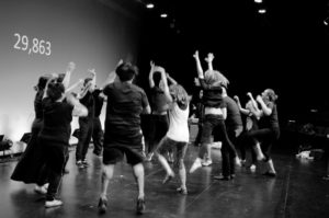 black and white photo and students dancing on stage
