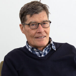 Headshot of Jim Shrosbree in front of a white wall.